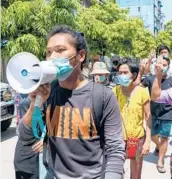  ?? AP ?? Demonstrat­ors march Saturday against the ruling junta in Yangon, Myanmar. Reports say 82 were killed Friday.