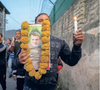  ?? ?? A CANDLELIGH­T PROTEST against the killing of Puran Krishan Bhat in Kashmir on October 16. Militants gunned him down the previous day outside his house at Chowdhary Gund village in Shopian in South Kashmir.