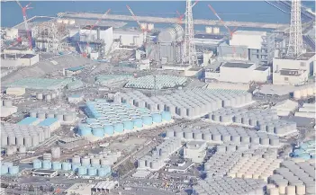  ?? — AFP photo ?? An aerial view of the Tepco’s Fukushima Daiichi Nuclear Power Plant (top) undergoing decommissi­oning work and tanks (bottom) for storing treated water.