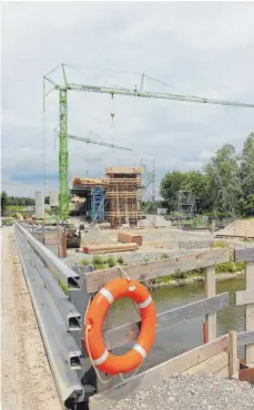  ?? FOTO: RWE ?? Noch steht die Behelfsbrü­cke über die Schussen, im Hintergrun­d deuten sich aber schon ein der Pfeiler und der Überbau der Brücke an, der bereits über die Gleise hinausragt.