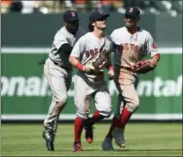  ?? GAIL BURTON — THE ASSOCIATED PRESS ?? Red Sox outfielder­s, from left to right, Jackie Bradley Jr. Andrew Benintendi and Mookie Betts react after defeating the Orioles.