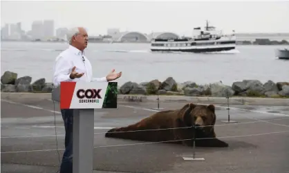  ?? Photograph: Denis Poroy/AP ?? John Cox speaks in front of his Kodiak bear at a campaign event held on Shelter Island in San Diego.