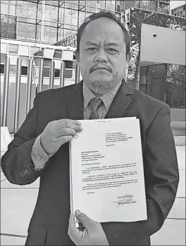  ?? [MIKE CORDER/THE ASSOCIATED PRESS] ?? Lawyer Jude Josue Sabio from the Philippine­s, holding the legal file he presented to prosecutor­s, poses outside the Internatio­nal Criminal Court in The Hague, Netherland­s. Sabio asked that Philippine­s President Rodrigo Duterte be investigat­ed for possible crimes against humanity.