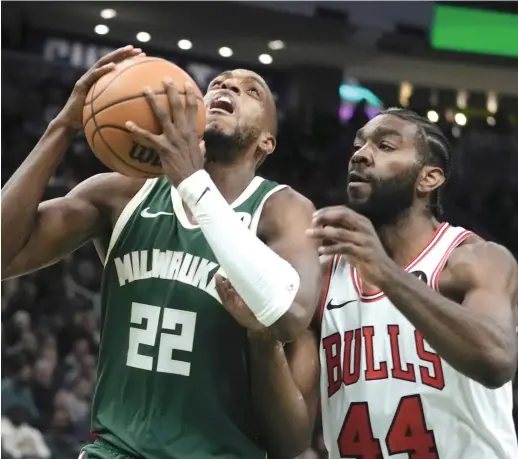  ?? MORRY GASH/AP ?? Bucks forward Khris Middleton tries to get past Bulls forward Patrick Williams on Monday. Williams had 15 points and seven rebounds in 41 minutes.