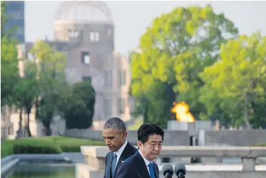  ?? JIM WATSONJIM WATSON/AFP/GETTY IMAGES FILES ?? Japanese Prime Minister Shinzo Abe, right, together with U.S. President Barack Obama, placed wreaths during a visit to the Hiroshima Peace Memorial Park in Hiroshima in May.