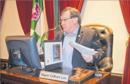  ?? DAVE STEWART/THE GUARDIAN ?? Outgoing Charlottet­own Mayor Clifford Lee takes his seat for the final time prior to city council’s regular public monthly meeting on Tuesday night. Lee will leave office next month as the longest serving mayor in the city’s history.