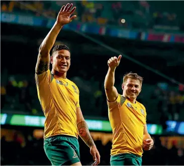  ??  ?? Once happy team-mates, Israel Folau, left, and Drew Mitchell celebrate victory for Australia over Wales in a pool match at the 2015 Rugby World Cup.
