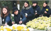  ?? PHOTOS BY SUN CAN/ XINHUA, WANG YE / XINHUA ?? Above: Members of the public place flowers on Wednesday for victims in Beijige, Nanjing, one of the sites where the Nanjing Massacre took place 80 years ago. Below: The State ceremony for the National Memorial Day for Victims of the Nanjing Massacre...