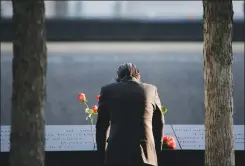  ?? AP PHOTO BY SETH WENIG ?? A man stands at the edge of a waterfall pool at ground zero during a ceremony on the 16th anniversar­y of the 9/11 attacks in New York, Monday. Holding photos and reading names of loved ones lost 16 years ago, 9/11 victims’ relatives marked the...