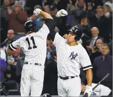  ?? Al Bello / Getty Images ?? The Yankees’ Brett Gardner (11) celebrates with Aaron Judge after hitting a home run in the AL wild-card game Tuesday.