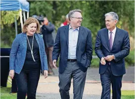  ?? [AP PHOTO] ?? From left, Esther George, President and CEO of the Federal Reserve Bank of Kansas City, John Williams, President and CEO of the Federal Reserve Bank of New York, and Jerome Powell, Chairman of the Board of Governors of the Federal Reserve System walk together after Powell’s speech at the Jackson Hole Economic Policy Symposium on Friday in Jackson Hole, Wyo. Powell signaled Friday that he expects the Fed to continue gradually raising interest rates if the U.S. economic expansion remains strong.