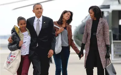  ?? | JEWEL SAMAD/ GETTY IMAGES FILES ?? President Barack Obama, first lady Michelle Obama and their daughters Sasha and Malia at O’Hare in 2012.