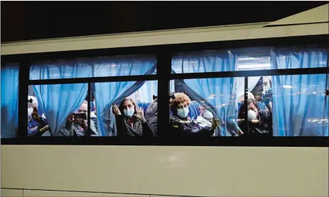  ?? JAE C. HONG/AP PHOTO ?? Buses carrying passengers from the quarantine­d Diamond Princess cruise ship leave a port in Yokohama, near Tokyo, Monday.