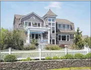  ??  ?? A Nantucket-style, wood-clad home designed by Baltimore architect Bob Berman and built in 2004. The weathered shingle exterior is typical of the Nantucket style while the simplicity and grace of the interior reflects the Arts and Crafts style.