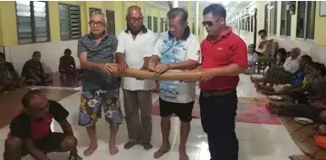  ??  ?? Andrew (standing second left) and Sarikei assistant unity officer Johnny Banyang (right) take part in the Ngiling Tikai ceremony.