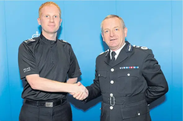  ??  ?? Inspector Chris Mutter, left, receiving his promotion from Chief Constable Iain Livingston­e. Father-of-two Chris died after a battle with cancer.