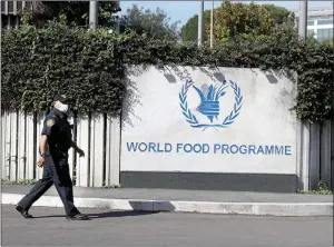  ??  ?? TheAssocia­tedPress
A security officer walks outside the headquarte­rs of the United Nations World Food Program (WFP), in Rome, Friday.