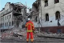  ?? AFP PHOTO ?? WRECKAGE
A Ukrainian rescuer stands next to a residentia­l building partially destroyed as a result of a missile attack in Kharkiv on Wednesday, Jan. 17, 2024. At least 17 people were wounded in Russian strikes on residentia­l buildings in the city center on Tuesday, January 16, the regional governor said.