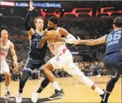  ?? Myung J. Chun Los Angeles Times ?? THE CLIPPERS’ Paul George drives past the Grizzlies’ Luke Kennard in a 42-point performanc­e.