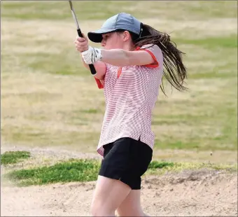  ?? PHOTOS BY RICK PECK/SPECIAL TO MCDONALD COUNTY PRESS ?? McDonald County’s Lily Allman blasts out of a sand trap during the Mustangs’ 197-210 win over Neosho on April 17 at Elk River Golf Course in Noel. Allman led McDonald County with a 47 over the par 36 course.