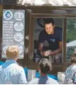  ?? Andy Cross, Denver Post file ?? Ross Cohen, co-owner of Sweet Cow, takes ice cream orders at his food truck at Civic Center in 2014.