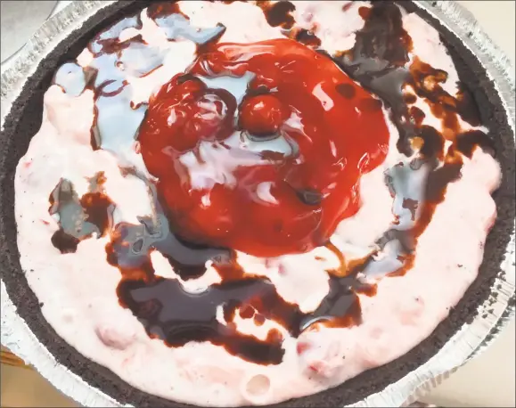  ?? Stephen Fries / For Hearst Connencnti­cut Media ?? This cherry-vanilla ice cream pie has an Oreo cookie crust with ice cream and pie filling. Top the ice cream and cherry mixture with remaining cherries and chocolate syrup.