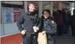  ??  ?? Troy Police Department Patrolman Emily Belanger and Patrolman Corey Barton visit Snowman Ice Cream on Sunday, its first day open for the 2020 season.