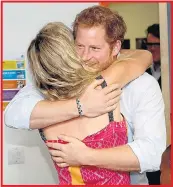  ??  ?? The Prince enjoys a chat and a hug with Joss while Chelsy Davy, below, relaxes at Glastonbur­y at the weekend