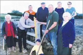  ?? ?? Glanworth County Councillor, Frank O’Flynn (2nd left) helping locals erect a concrete fence at a once derelict site at Ballindang­an Cross. It was hoped the site, where the Old Forge owned by the O’Keeffe’s once stood, would be transforme­d into an attractive green area. Included in the picture are Maura Fitzgerald (left), Margaret Murphy (right), along with Colm Baker, Jim Baker, Gerard Murphy, Catherine Murphy and Catherine Cotter - the boy in front is Ciarán Murphy.