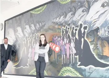  ??  ?? Work of art Multi-talented Hollie showcases her spectacula­r mural alongside Ashley Moon