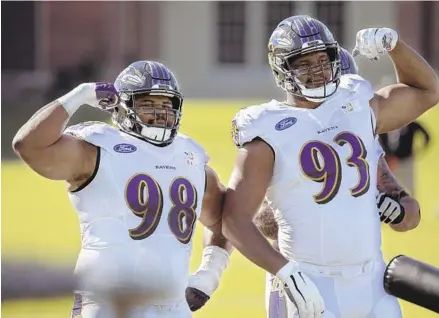  ?? KARL MERTON FERRON/BALTIMORE SUN ?? Ravens defensive tackle Brandon Williams, left, and defensive end Calais Campbell flex at the team’s training facility on Tuesday.