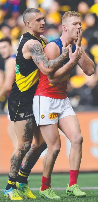  ??  ?? Lions agitator Nick Robertson reacts to Dustin Martin’s contact with his face and (top right) his head clash with Trent Cotchin that led to him being reported. Pictures: AAP IMAGES, GETTY IMAGES