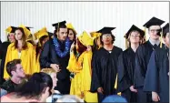  ??  ?? Graduates line up to receive their diplomas on Friday at Burton Horizon Academy’s final graduation ceremony. BHA will close at the end of the school year.