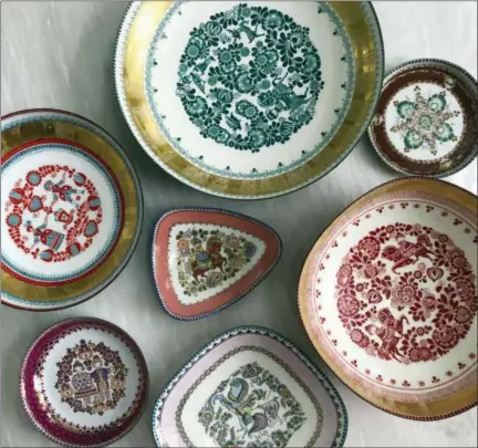  ?? JENNY DINA KIRSCHNER VIA AP ?? This undated photo provided by Jenny Dina Kirschner shows vintage plates. Interior designer Kirschner discovered one of these vintage Steinbock Enamel candy dishes at a flea market, then searched online for other pieces in the same series.