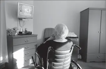  ?? Associated Press ?? An elderly woman who has suffered abuse by a relative watches “I Love Lucy” on a television Jan. 8 inside her room at Cedar Village retirement community in Mason, Ohio. The Shalom Center that is a part of the community helps the woman by offering...