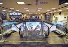  ?? PATRICK DOVE, TREASURE COAST NEWSPAPERS ?? Yellow caution tape blocks an entrance to the baggage claim area in Terminal 2 of the Fort Lauderdale-Hollywood Internatio­nal Airport on Sunday, two days after the shooting there.