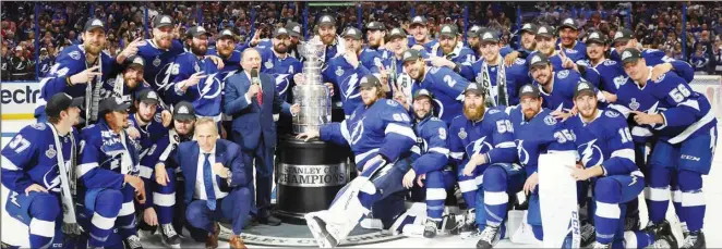  ??  ?? The Tampa Bay Lightning pose with the Stanley Cup after defeating the Montreal Canadiens 1-0 in Game 5 to win the NHL hockey Stanley Cup Finals in Tampa, Fla. (AP)