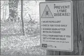  ?? CUTLINE CREDIT GOES HERE ?? A trail-side warning from the Centers for Disease Control and Prevention about the prevention of tick-borne Lyme disease.