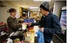  ?? GENE J. PUSKAR/AP ?? Dianne Shenk (left), owner of Dylamatos Market in Pittsburgh, lauds SNAP choices.