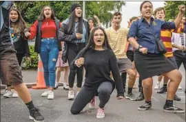  ?? Carl Court Getty Images ?? MOURNERS perform a haka, a dance of New Zealand’s Maori people, during the vigil — held at a park across from Al Noor mosque, a site of Friday’s massacre.