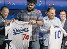  ?? Marcus Yam Los Angeles Times ?? DODGERS MANAGER Dave Roberts, closer Kenley Jansen, third baseman Justin Turner and President of Baseball Operations Andrew Friedman, from left, at a news conference at Dodger Stadium reintroduc­ing the two players.