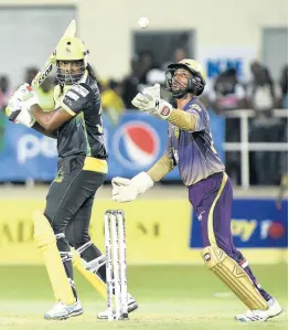  ?? FILE ?? Chris Gayle (left), then of the Jamaica Tallawahs, looks around to see if Trinbago Knight Riders wicketkeep­er Denesh Ramdin had dismissed him during their Caribbean Premier League game at Sabina Park on Friday, September 13, 2019.