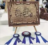  ?? SPECIAL TO THE EXAMINER ?? At the Kawartha Carving Competitio­n, Bob Gill, posthumous­ly won the Best of Show for his relief carving of two ships. This carving also won the best in the open category for relief and the best in the whole open class.