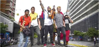  ??  ?? CARACAS: Opposition activists block an avenue during a protest. — AFP