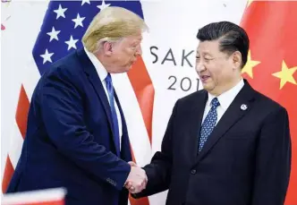  ??  ?? In this file photo taken on June 28, 2019, China’s President Xi Jinping shakes hands with US President Donald Trump before a bilateral meeting on the sidelines of the G20 Summit in Osaka.