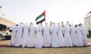  ??  ?? Emirati men perform a traditiona­l Al Ayala group dance at the Abu Dhabi Culture and Tourism pavilion at the Sheikh Zayed Heritage Festival