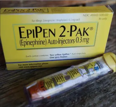  ?? ASSOCIATED PRESS FILE ?? This Oct. 10, 2013, file photo, shows an EpiPen epinephrin­e auto-injector, a Mylan product, in Hendersonv­ille, Texas. Mylan, now in the crosshairs over severe price hikes for its EpiPen, said Thursday, Aug. 25, it will expand programs that lower...