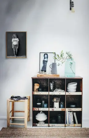  ??  ?? THIS PAGE (from left) Atop the kitchen’s vintage metal shelving unit is a large glass jar from Baileys, a chopping board made by Karine’s father, a white water jug by Nelson Sepulveda and a grey water jug from H&M; the stool is from Moroccan Bazaar, the jute rug from Marks & Spencer Home, and the portrait on the wall is by Karine. The kitchen’s Ball chair in White is by XL Boom.