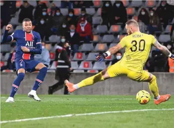  ?? (AFP) ?? Paris Saint-Germain’s forward Kylian Mbappe (left) scores against Nimes during the Ligue 1 match in Nimes, France.