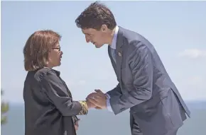  ?? Photo: AFP ?? Hilda Heine, (left), is greeted by Canada Prime Minister Justin Trudeau at the G7 summit.